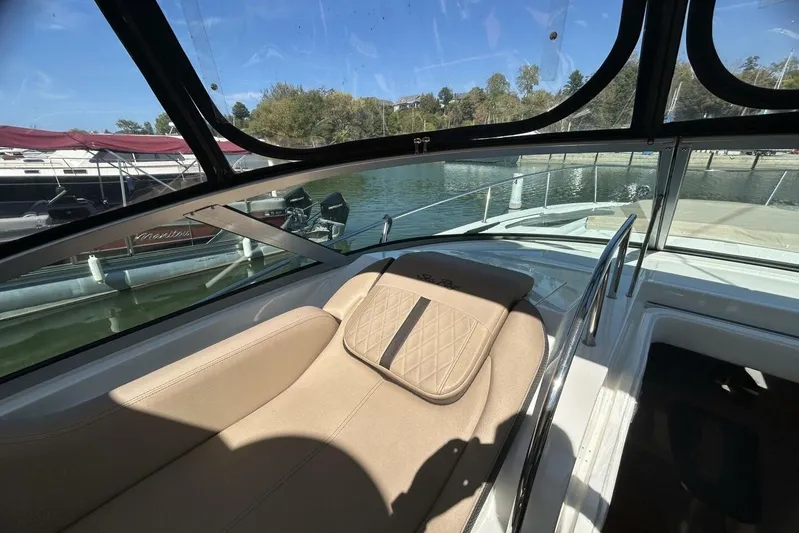  Yacht Photos Pics Interior view of 2016 Sea Ray 350 Sundancer boat with beige seating and waterfront backdrop.
