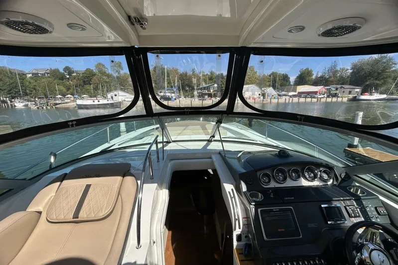  Yacht Photos Pics Interior view of 2016 Sea Ray 350 Sundancer yacht cockpit with scenic marina backdrop.