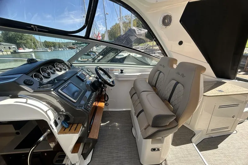  Yacht Photos Pics Interior of 2016 Sea Ray 350 Sundancer boat with helm and seating area.
