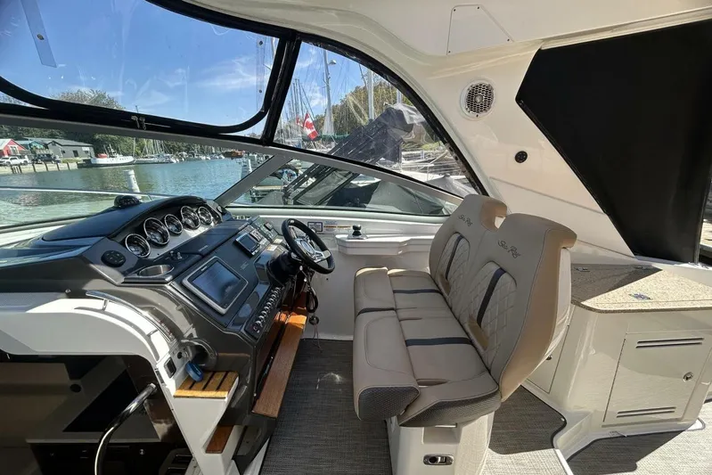  Yacht Photos Pics Interior of 2016 Sea Ray 350 Sundancer boat with helm and seating area.
