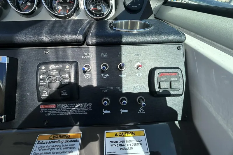  Yacht Photos Pics Control panel of a 2016 Sea Ray 350 Sundancer boat with various switches and warnings.