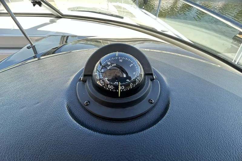  Yacht Photos Pics Compass on 2016 Sea Ray 350 Sundancer boat dashboard, near water.