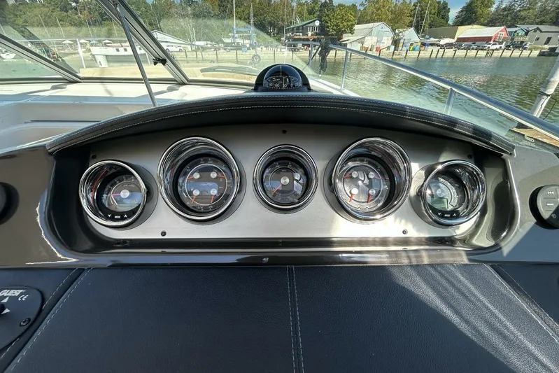  Yacht Photos Pics Dashboard of 2016 Sea Ray 350 Sundancer boat with five chrome-rimmed gauges.