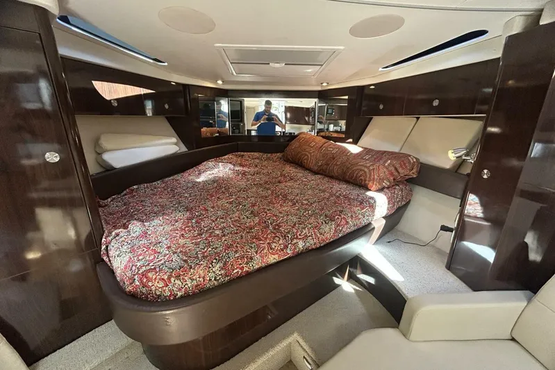  Yacht Photos Pics Luxurious interior of 2016 Sea Ray 350 Sundancer with elegant bedding and wood finishes.