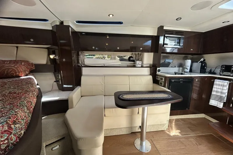  Yacht Photos Pics Interior of 2016 Sea Ray 350 Sundancer yacht with modern kitchen and cozy seating area.