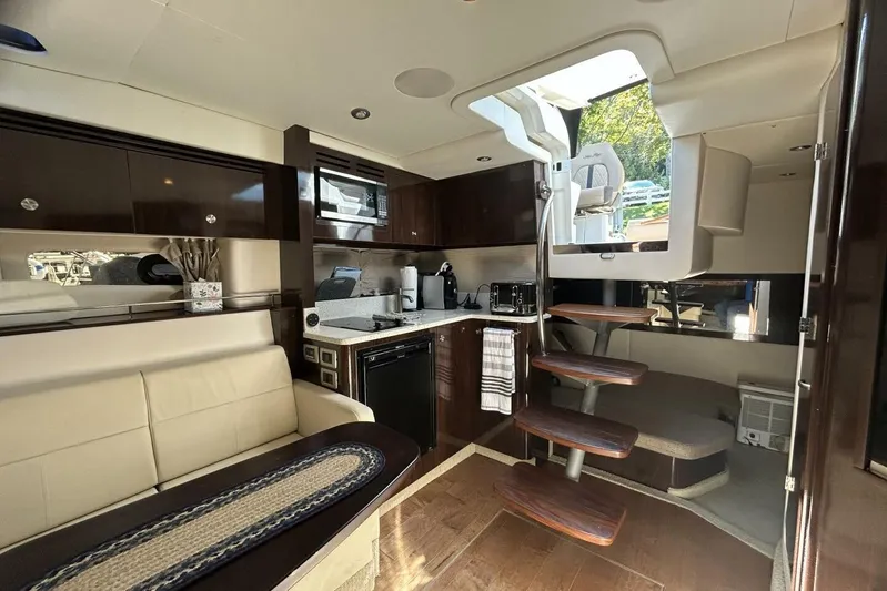  Yacht Photos Pics Luxurious interior of 2016 Sea Ray 350 Sundancer yacht with modern kitchen and seating area.