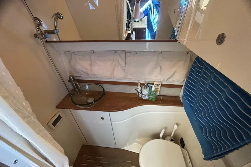 Yacht Photos Pics Compact bathroom in 2016 Sea Ray 350 Sundancer yacht with modern fixtures and amenities.