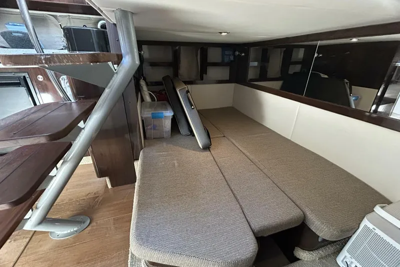  Yacht Photos Pics Interior cabin of 2016 Sea Ray 350 Sundancer with beige seating and wooden accents.