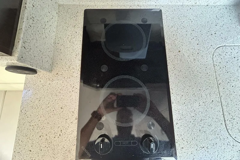  Yacht Photos Pics Stovetop on Sea Ray 350 Sundancer 2016 yacht, sleek black design, granite countertop.