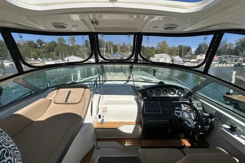  Yacht Photos Pics Interior view of 2016 Sea Ray 350 Sundancer yacht cockpit with steering wheel and seating.