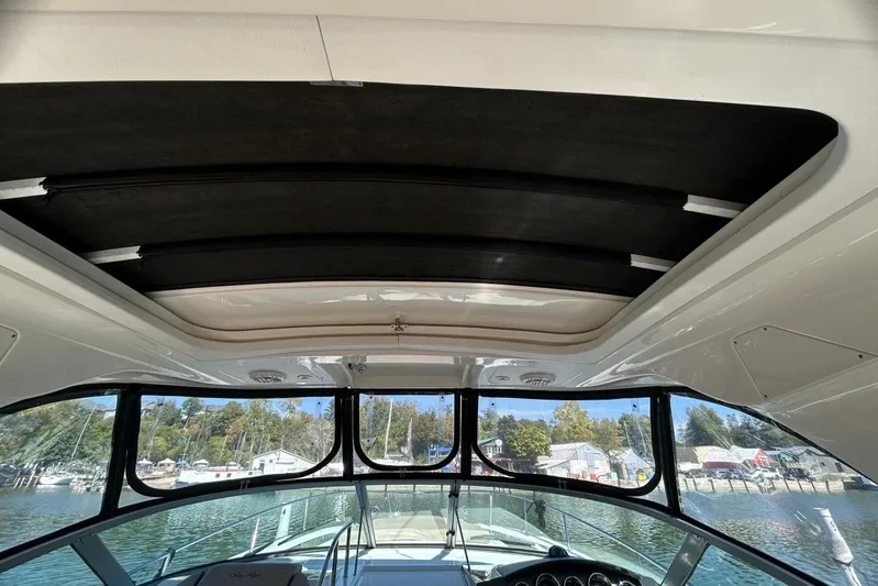  Yacht Photos Pics Interior view of 2016 Sea Ray 350 Sundancer boat with sunroof and scenic marina backdrop.