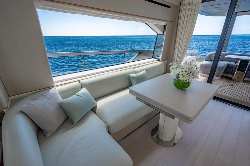 Effortless Yacht Photos Pics Luxurious interior of 2023 Azimut Fly 68 yacht with ocean view and elegant seating area.