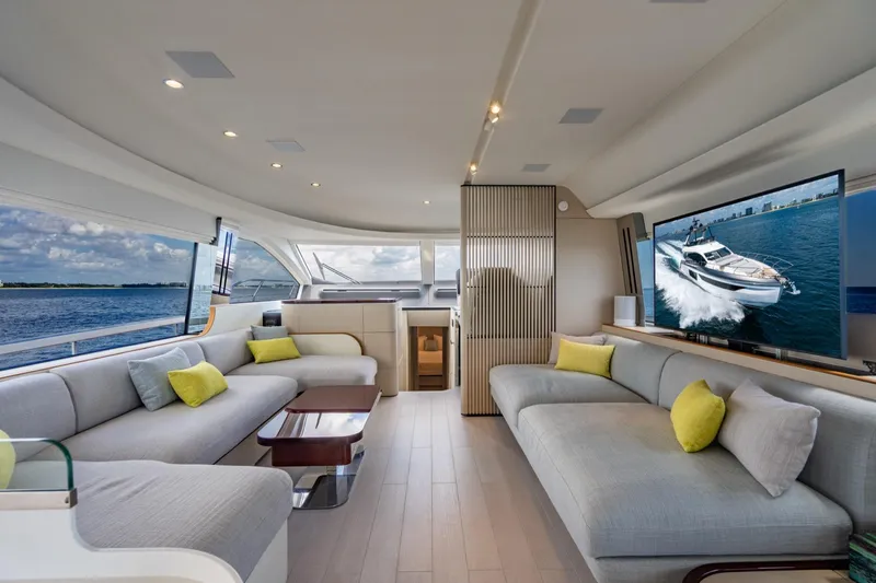 Effortless Yacht Photos Pics Luxurious interior of 2023 Azimut Fly 68 yacht with modern seating and large windows.