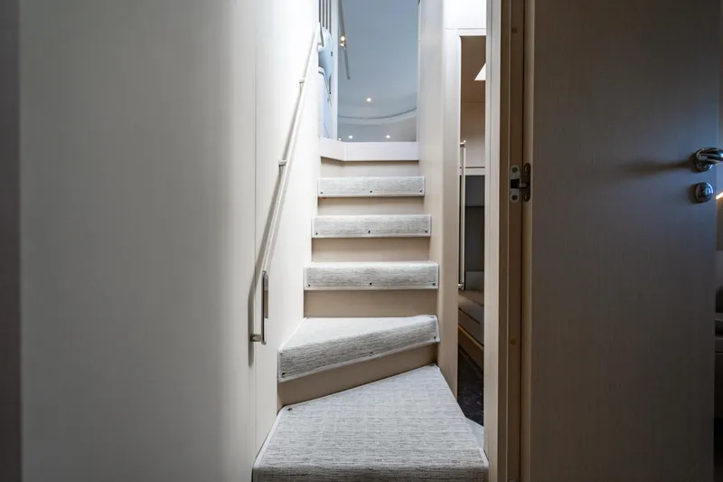 Effortless Yacht Photos Pics Staircase inside 2023 Azimut Fly 68 yacht, featuring modern design and soft lighting.