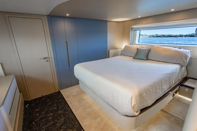 Effortless Yacht Photos Pics Luxurious bedroom interior of 2023 Azimut Fly 68 yacht with ocean view.