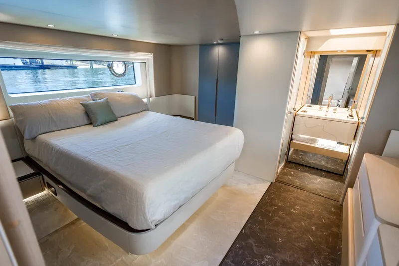 Effortless Yacht Photos Pics Luxurious bedroom interior of 2023 Azimut Fly 68 yacht with modern design and elegant furnishings.