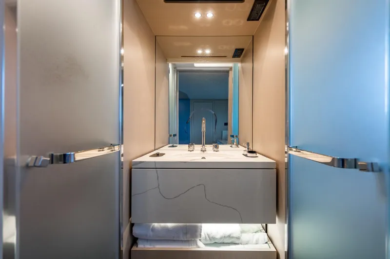 Effortless Yacht Photos Pics Luxurious bathroom interior of 2023 Azimut Fly 68 yacht with modern fixtures and elegant design.