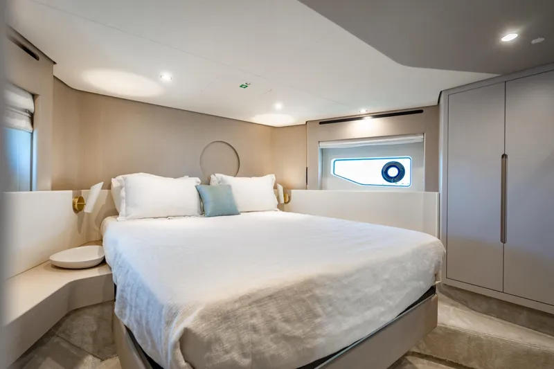 Effortless Yacht Photos Pics Luxurious bedroom interior of 2023 Azimut Fly 68 yacht, featuring modern design and elegant furnishings.