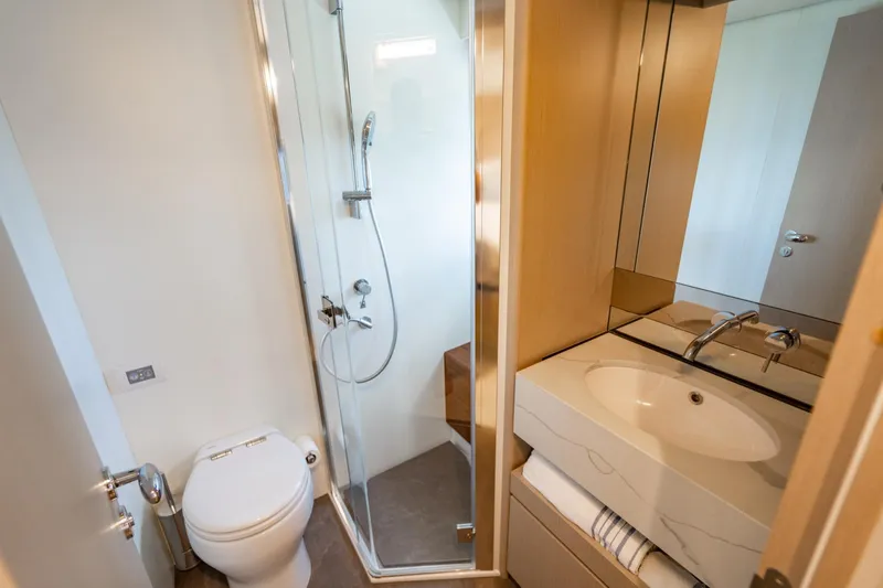 Effortless Yacht Photos Pics Luxurious bathroom in 2023 Azimut Fly 68 yacht with modern shower and sink.