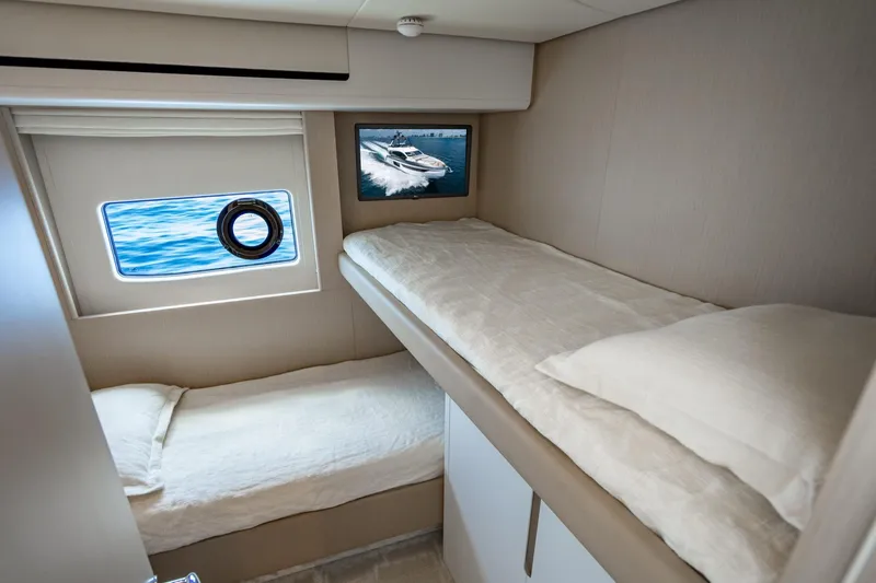 Effortless Yacht Photos Pics 2023 Azimut Fly 68 yacht cabin with bunk beds and ocean view window.
