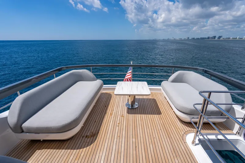 Effortless Yacht Photos Pics Luxury deck of 2023 Azimut Fly 68 yacht with ocean view and seating area.