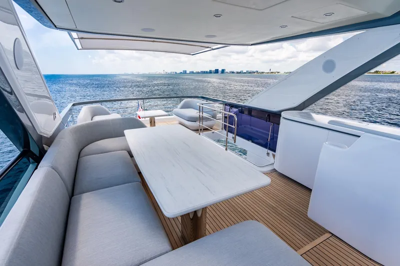 Effortless Yacht Photos Pics Luxurious 2023 Azimut Fly 68 yacht deck with elegant seating and ocean view.