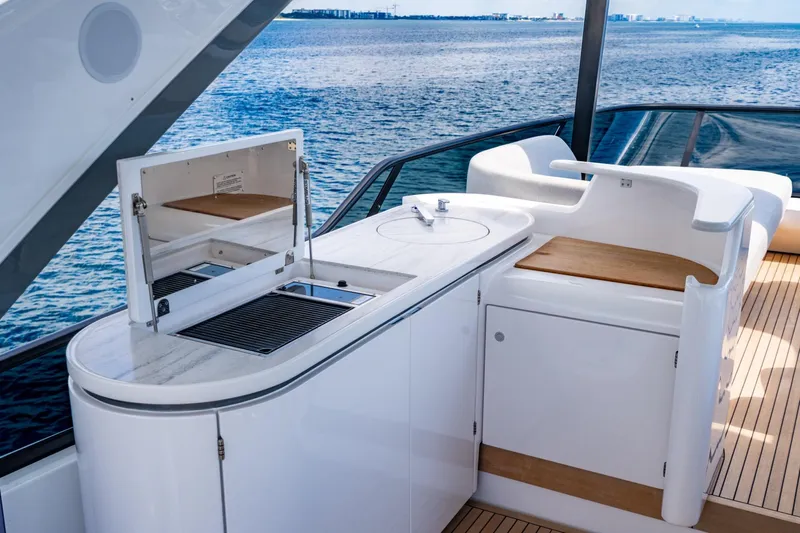 Effortless Yacht Photos Pics Luxurious 2023 Azimut Fly 68 yacht deck with sleek outdoor kitchen and ocean view.