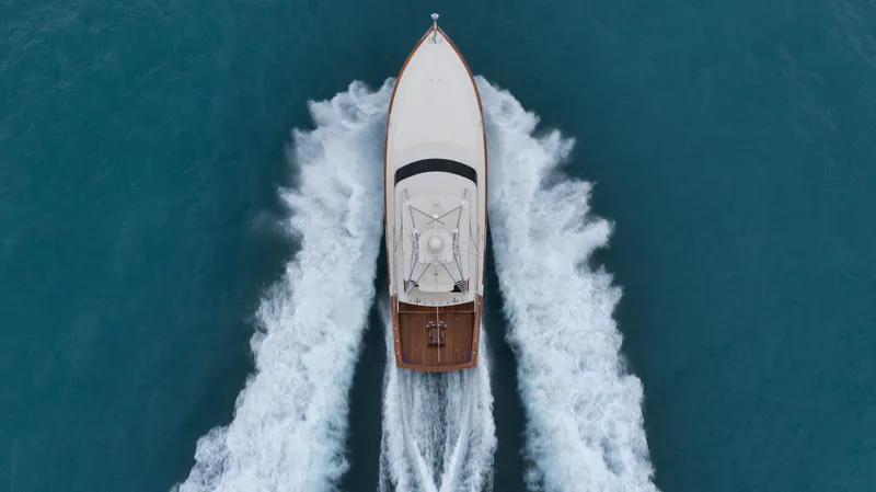 Whiskey Kilo Yacht Photos Pics Aerial view of 2004 Hines-Farley Custom Convertible yacht cruising on blue ocean waters.