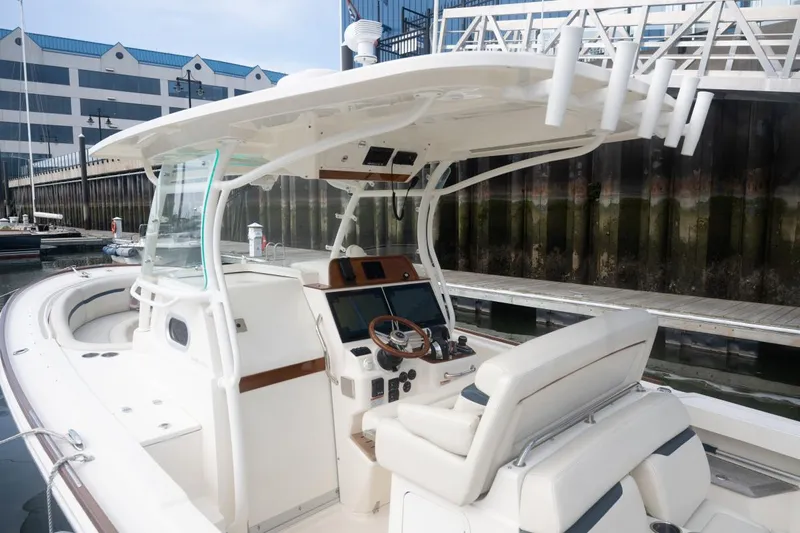 Malihini Yacht Photos Pics 2019 Hunt Yachts 32 Center Console at dock, featuring sleek design and modern controls.