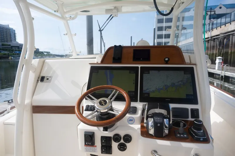 Malihini Yacht Photos Pics 2019 Hunt Yachts 32 Center Console helm with dual navigation screens and steering wheel.