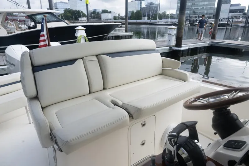 Malihini Yacht Photos Pics 2019 Hunt Yachts 32 Center Console with plush seating at marina dock.
