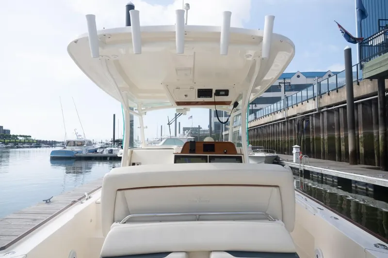Malihini Yacht Photos Pics 2019 Hunt Yachts 32 Center Console docked at marina, showcasing helm and seating area.