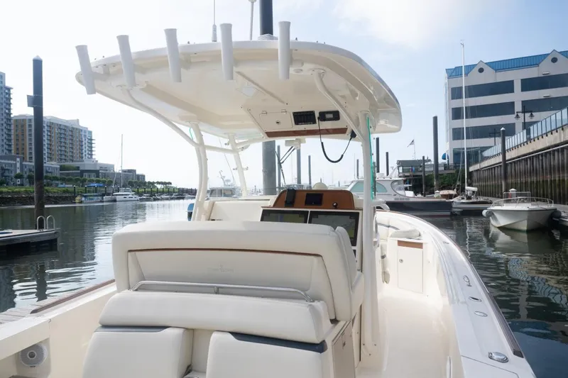 Malihini Yacht Photos Pics 2019 Hunt Yachts 32 Center Console docked in a marina, showcasing sleek design and modern features.