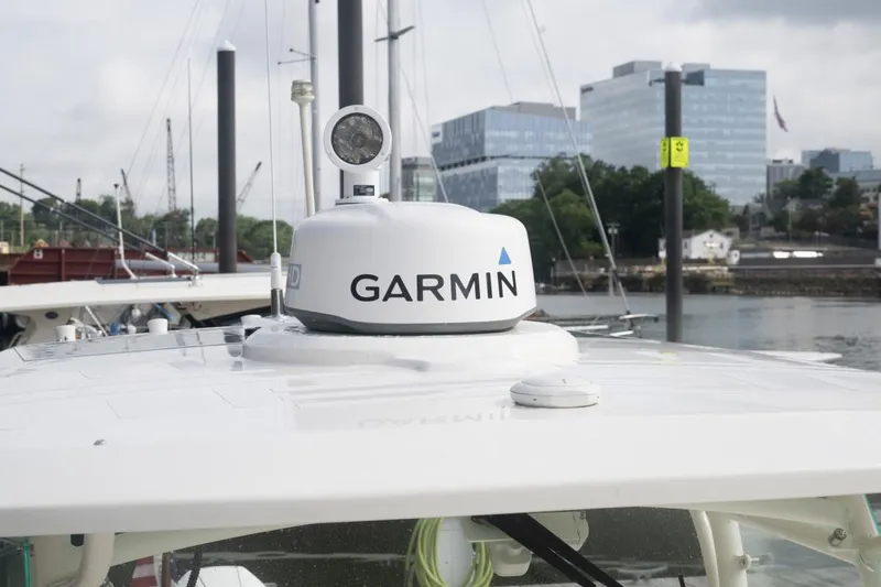Malihini Yacht Photos Pics 2019 Hunt Yachts 32 Center Console with Garmin radar, docked near modern buildings.