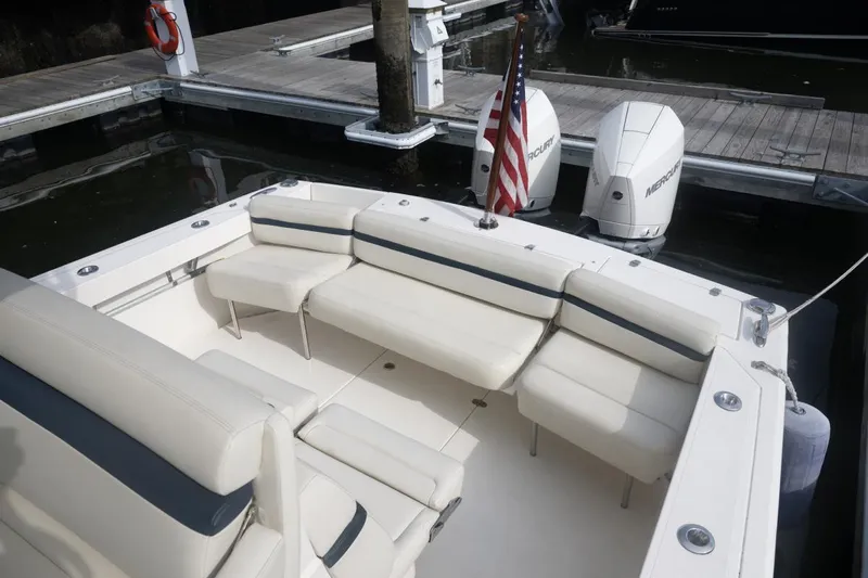 Malihini Yacht Photos Pics 2019 Hunt Yachts 32 Center Console with white seating and twin Mercury engines at dock.