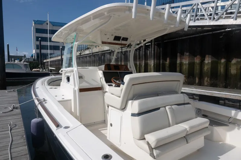 Malihini Yacht Photos Pics 2019 Hunt Yachts 32 Center Console docked, showcasing sleek design and spacious seating.