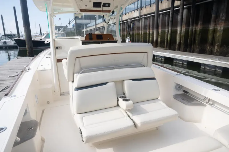 Malihini Yacht Photos Pics 2019 Hunt Yachts 32 Center Console with white seating, docked at a marina.