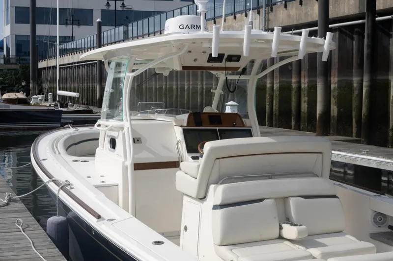 Malihini Yacht Photos Pics 2019 Hunt Yachts 32 Center Console docked, featuring sleek design and modern navigation equipment.