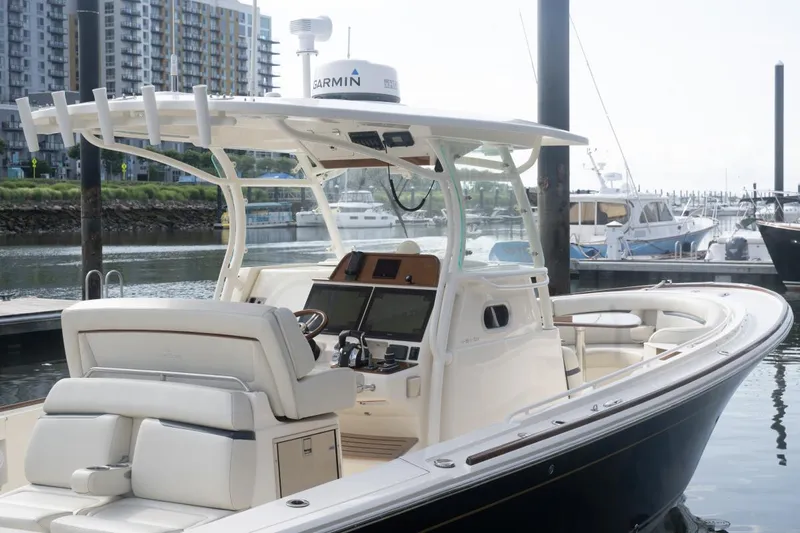 Malihini Yacht Photos Pics 2019 Hunt Yachts 32 Center Console docked, featuring sleek design and modern navigation equipment.