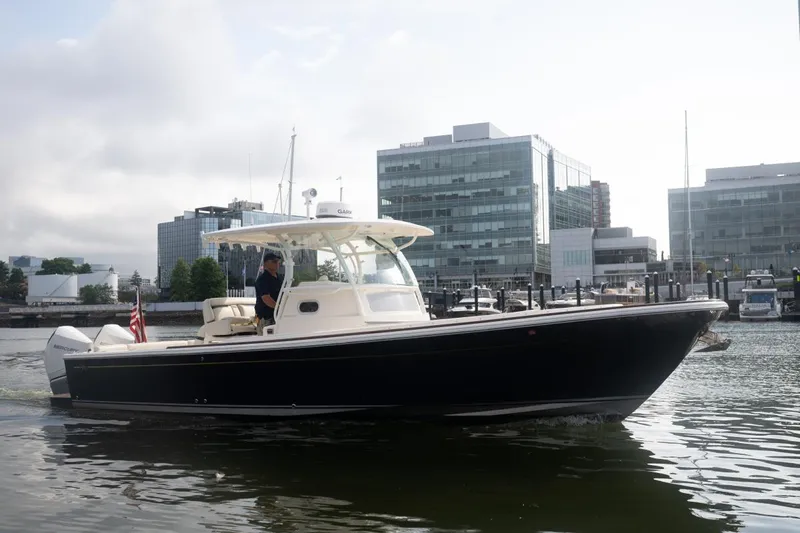 Malihini Yacht Photos Pics 2019 Hunt Yachts 32 Center Console cruising in urban marina setting.
