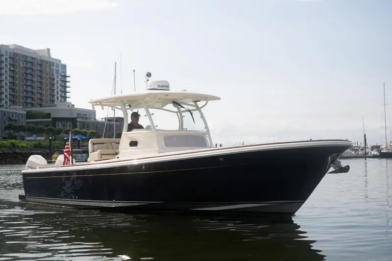 Malihini Yacht Photos Pics 2019 Hunt Yachts 32 Center Console on calm water near urban buildings.