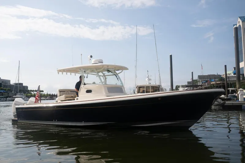 Malihini Yacht Photos Pics 2019 Hunt Yachts 32 Center Console boat docked in a marina under a clear sky.
