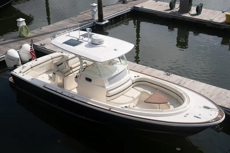 Malihini Yacht Photos Pics 2019 Hunt Yachts 32 Center Console docked, featuring sleek design and spacious seating.
