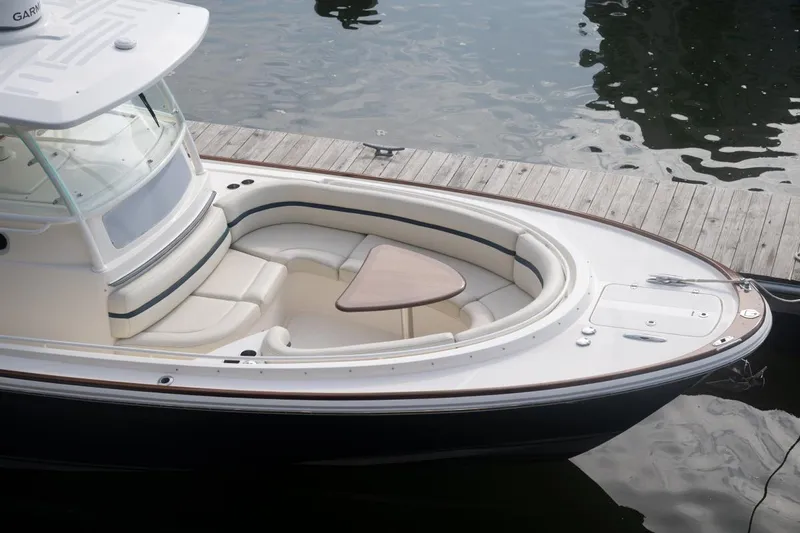Malihini Yacht Photos Pics 2019 Hunt Yachts 32 Center Console docked, featuring spacious seating and elegant design.