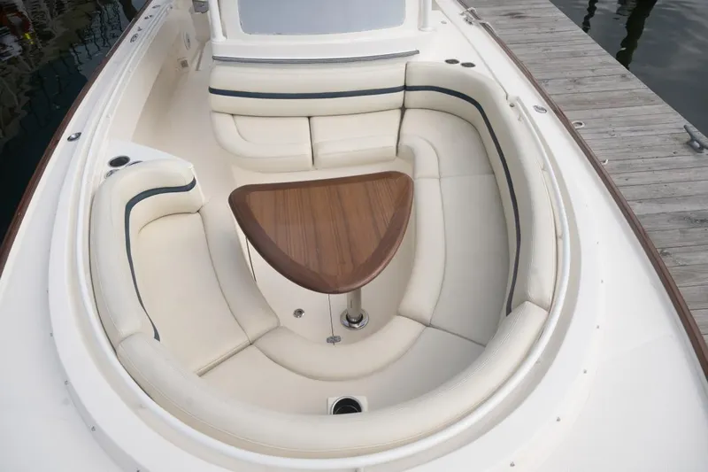 Malihini Yacht Photos Pics 2019 Hunt Yachts 32 Center Console with elegant seating and wooden table.