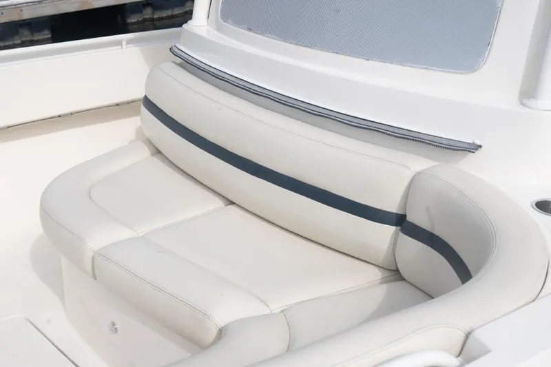 Malihini Yacht Photos Pics 2019 Hunt Yachts 32 Center Console, white cushioned seating with blue accent stripe.