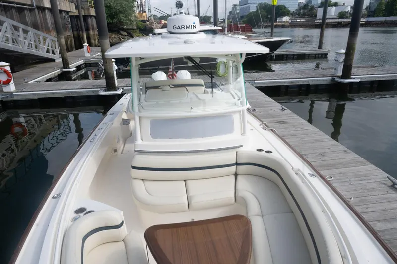 Malihini Yacht Photos Pics 2019 Hunt Yachts 32 Center Console docked, featuring spacious seating and Garmin equipment.