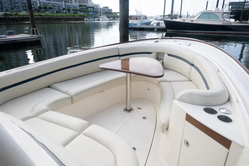 Malihini Yacht Photos Pics 2019 Hunt Yachts 32 Center Console with elegant seating and table, docked in a marina.