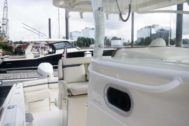 Malihini Yacht Photos Pics 2019 Hunt Yachts 32 Center Console at marina, featuring sleek design and comfortable seating.