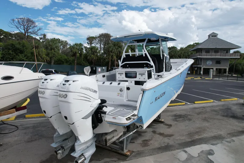  Yacht Photos Pics 2023 Blackfin 332 CC boat with twin Mercury 400 engines, docked outdoors.